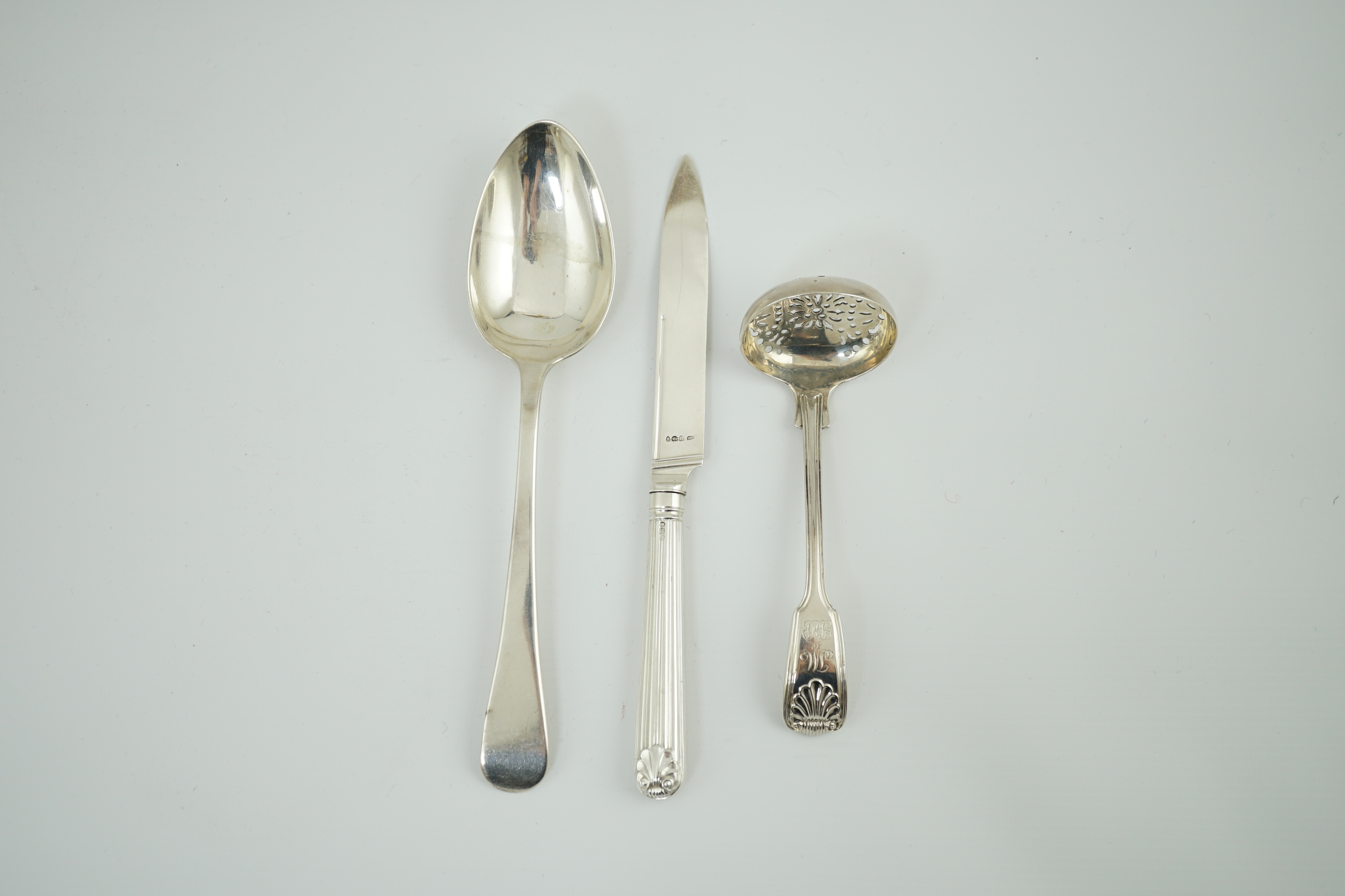 Paul Storr. A George III silver fiddle, thread and shell pattern sifter ladle, London, 1815, 13.9cm, a similar Old English pattern table spoon, London, 1818, 21.2cm, 4oz and a dessert knife, London, 1812.